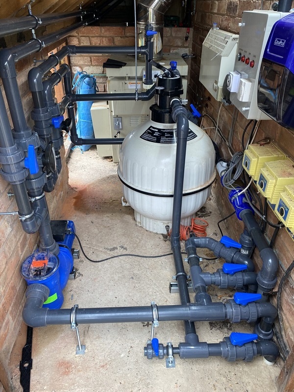 Photograph of some PVC pipework for a small pool plant room.